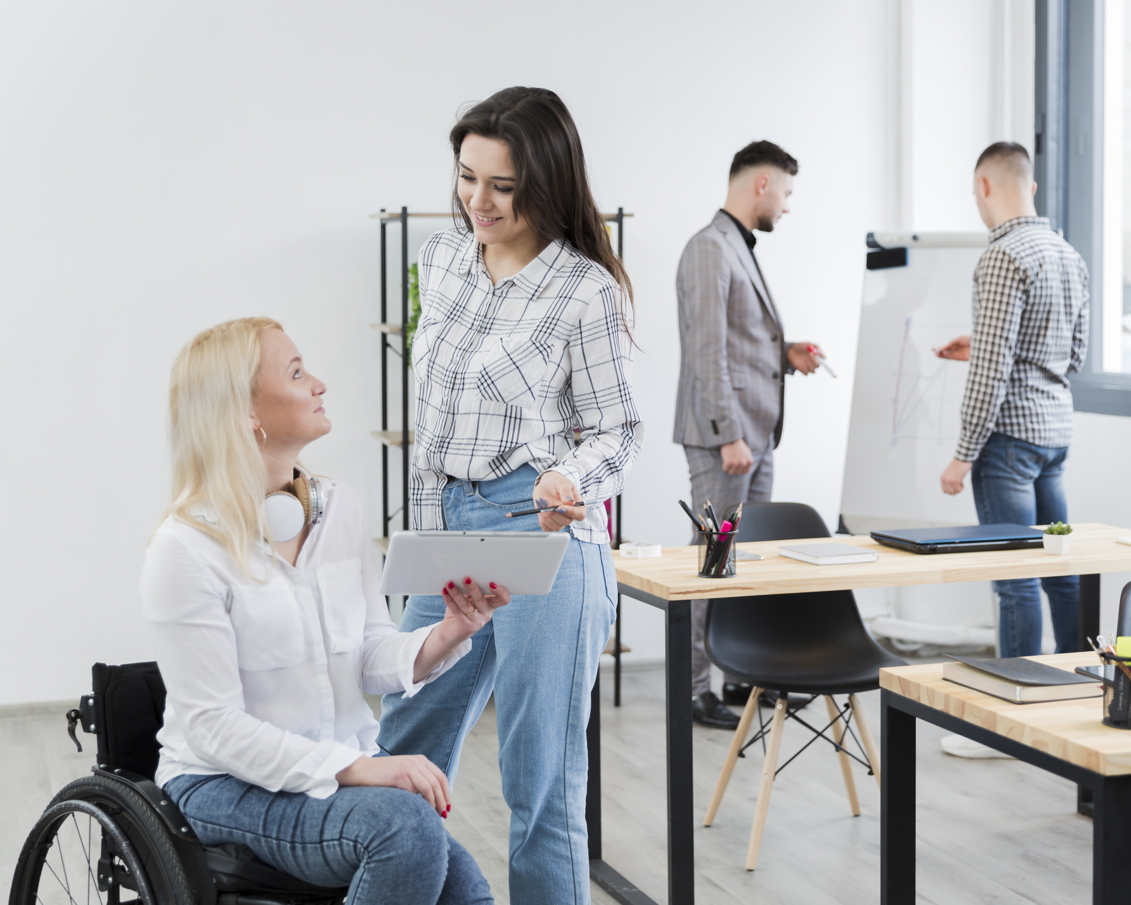 Care worker supporting participant in a collaborative office setting